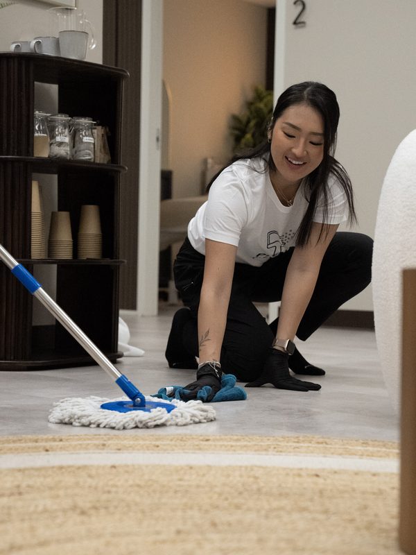 Pixel Cleaners professional mopping floor with a smile