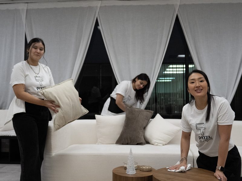 Airbnb turnover cleaning team making bed