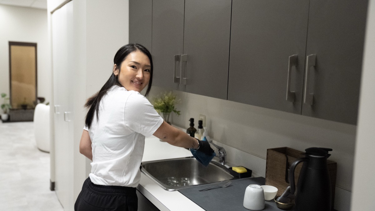 Pixel Cleaners team member vacuuming living room in Metro Vancouver