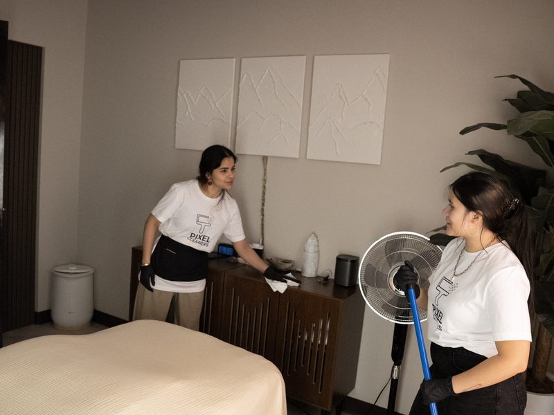 Pixel Cleaners cleaning team arranging living room cushions