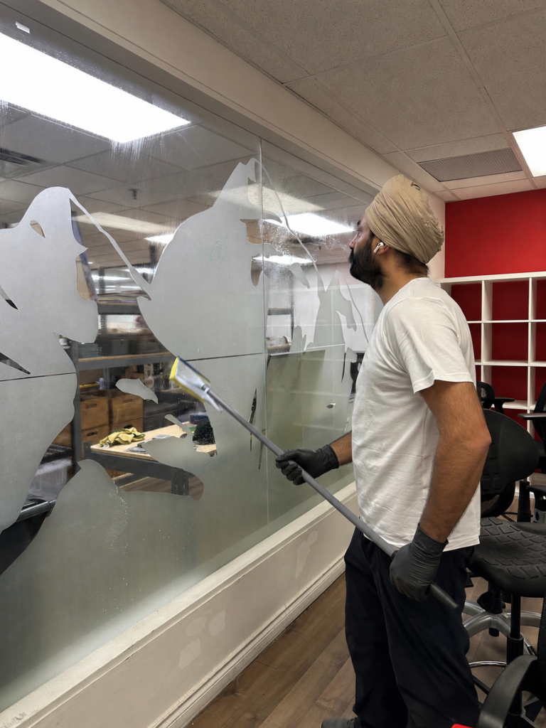 Cleaning window inside office